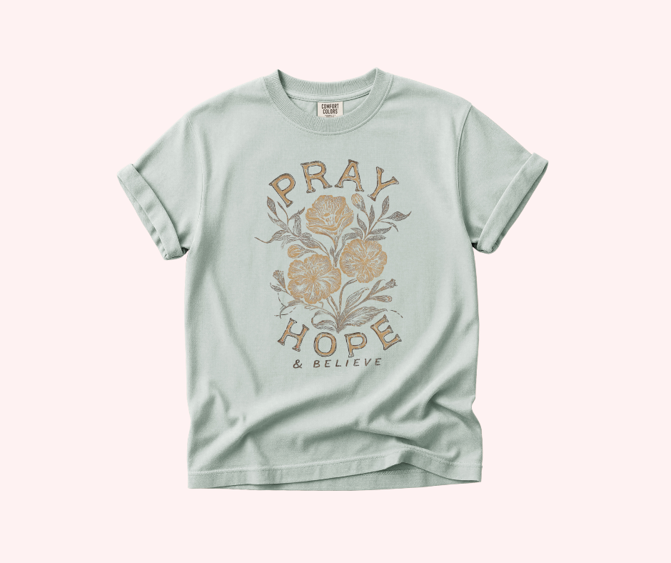 Mint green t-shirt with floral design and text on a white background