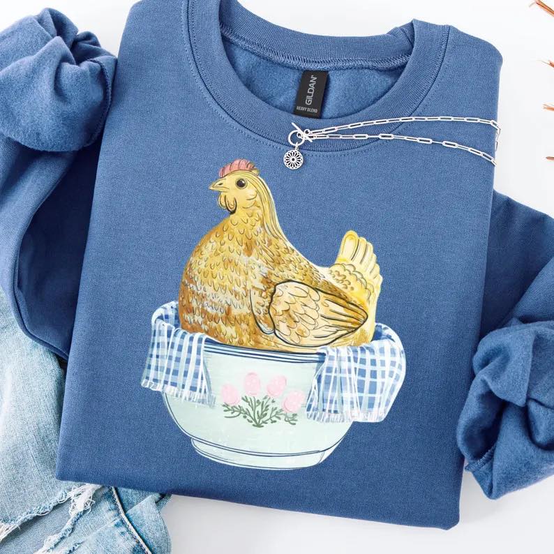 Blue sweatshirt with a chicken design on a white background